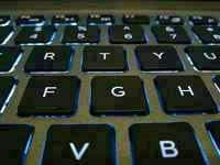 Backlit laptop keyboard, illustrating what forex actually is (and isn't)